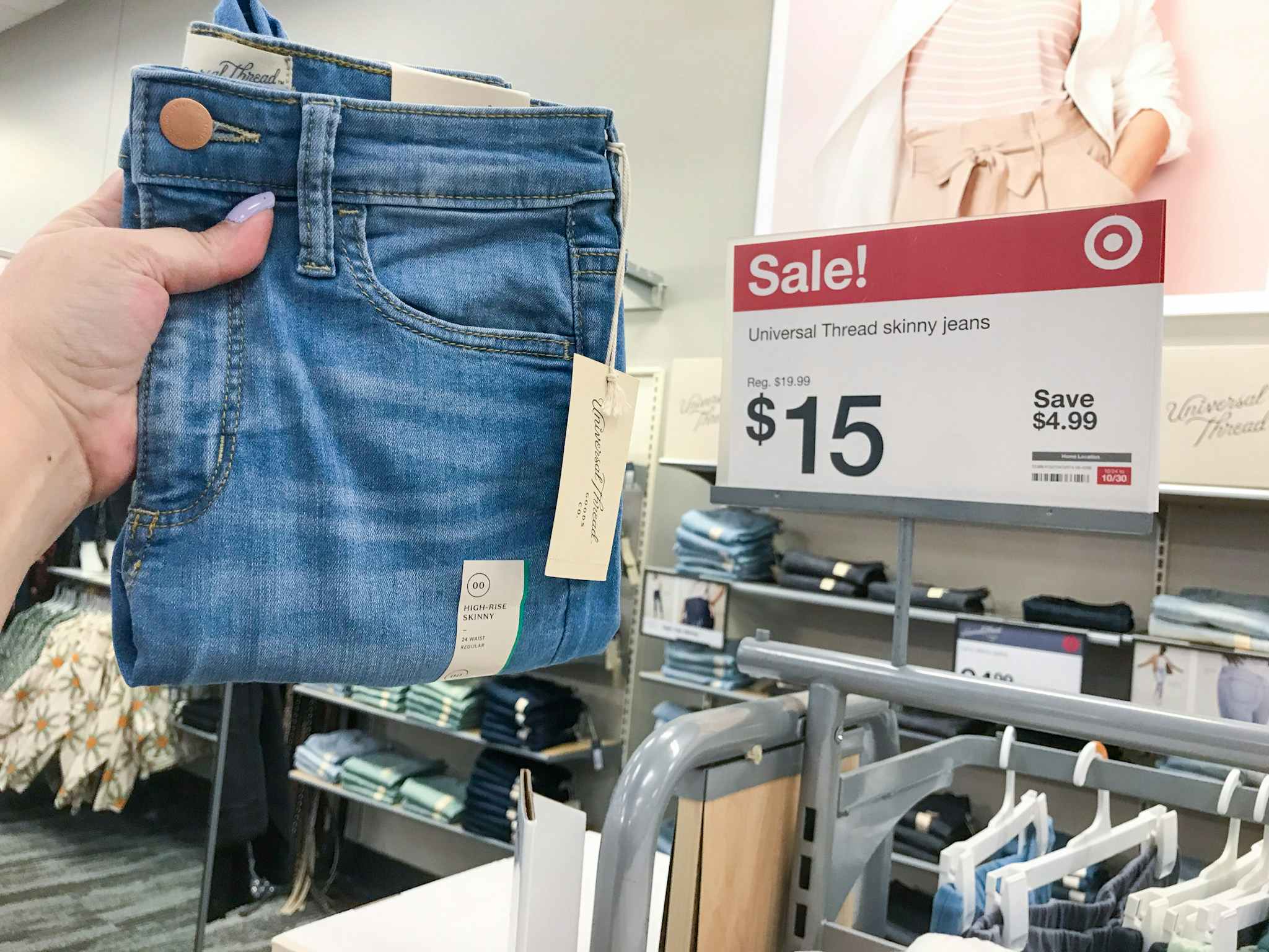 hand holding a pair of universal thread women's jeans at Target