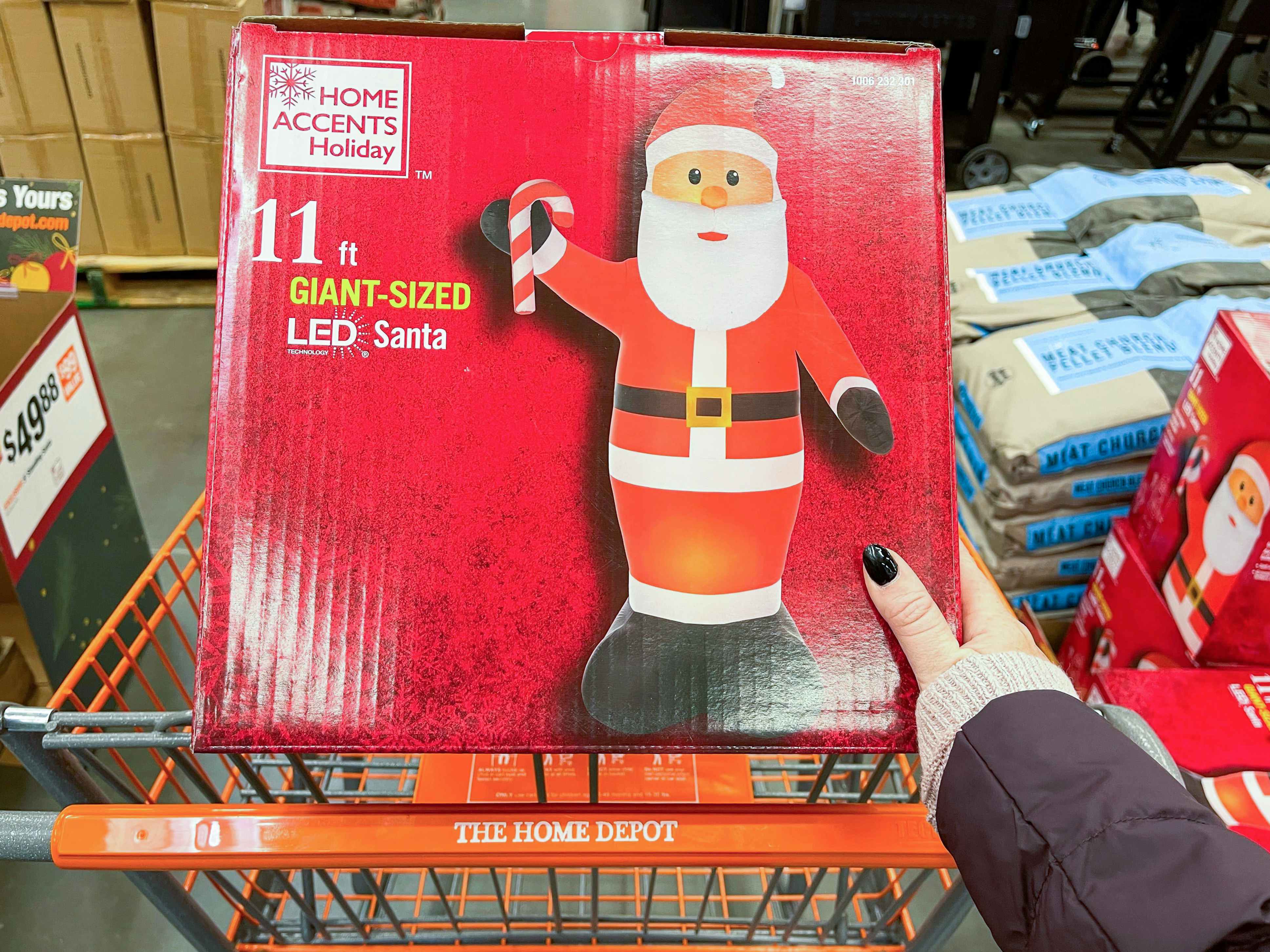 hand holding box for 11-ft inflatable santa at Home Depot