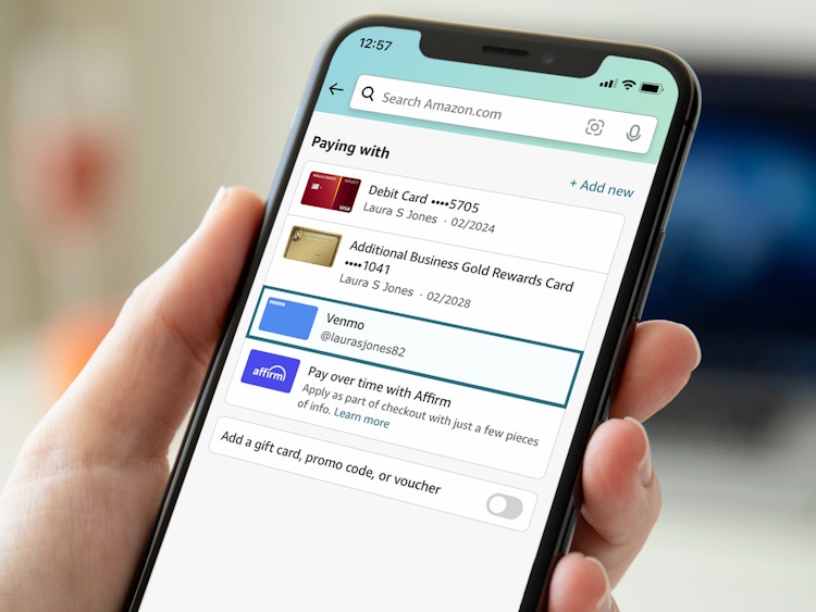 person on iphone checking out on amazon app using venmo payment option