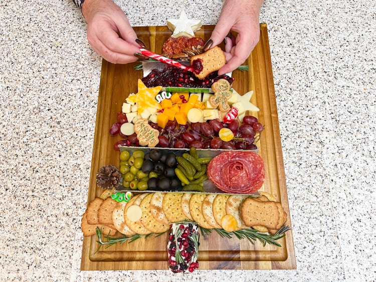 charcuterie board made into the shade of a christmas tree 