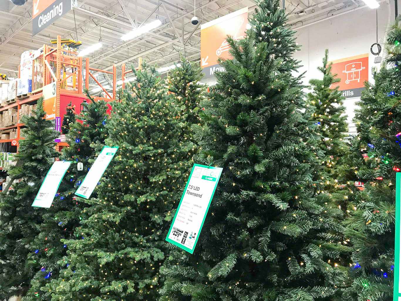 after christmas sales - Artificial Christmas trees for the Christmas Tree Clearance event displayed inside a Home Depot.