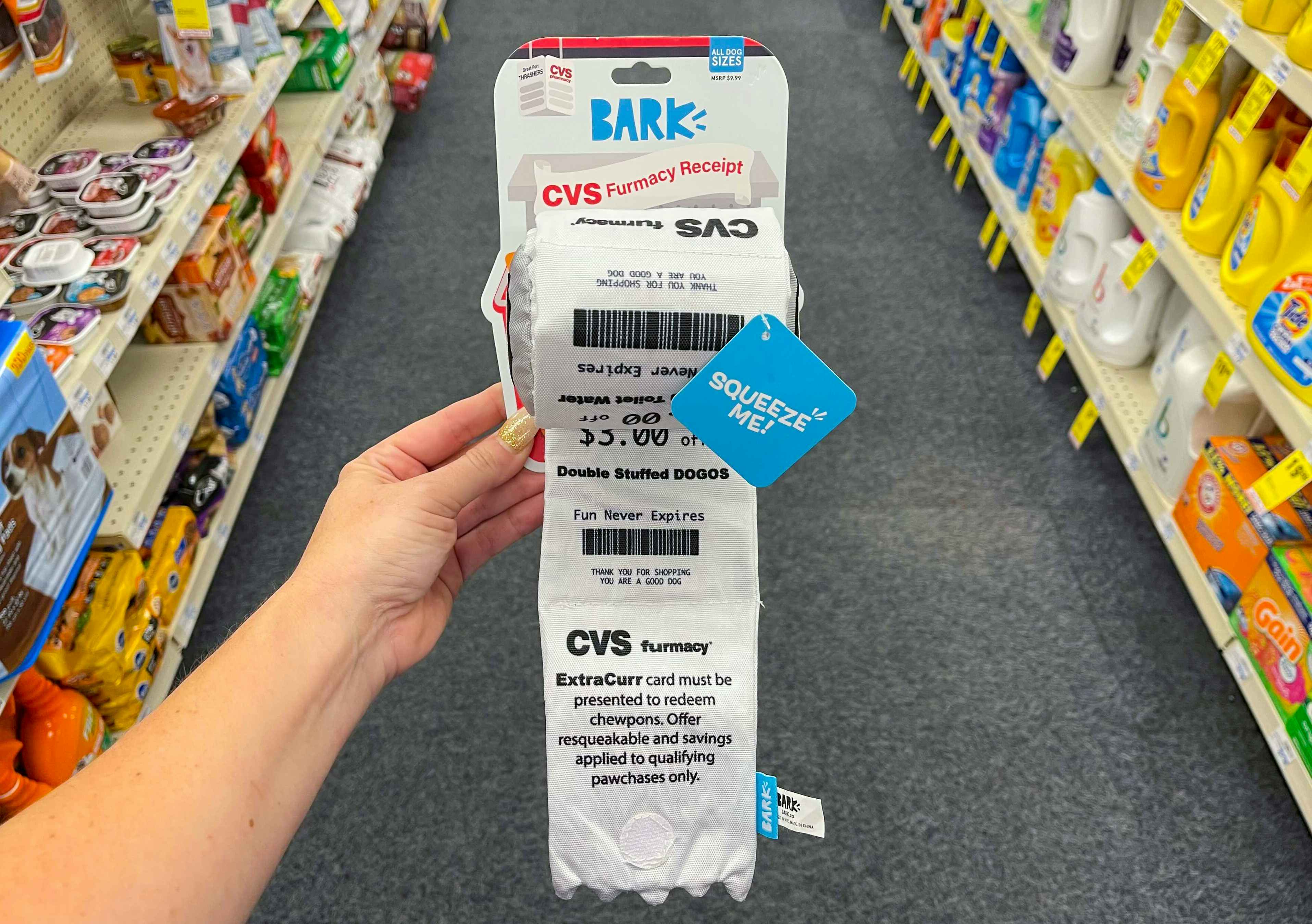 someone holding cvs receipt with coupons on it