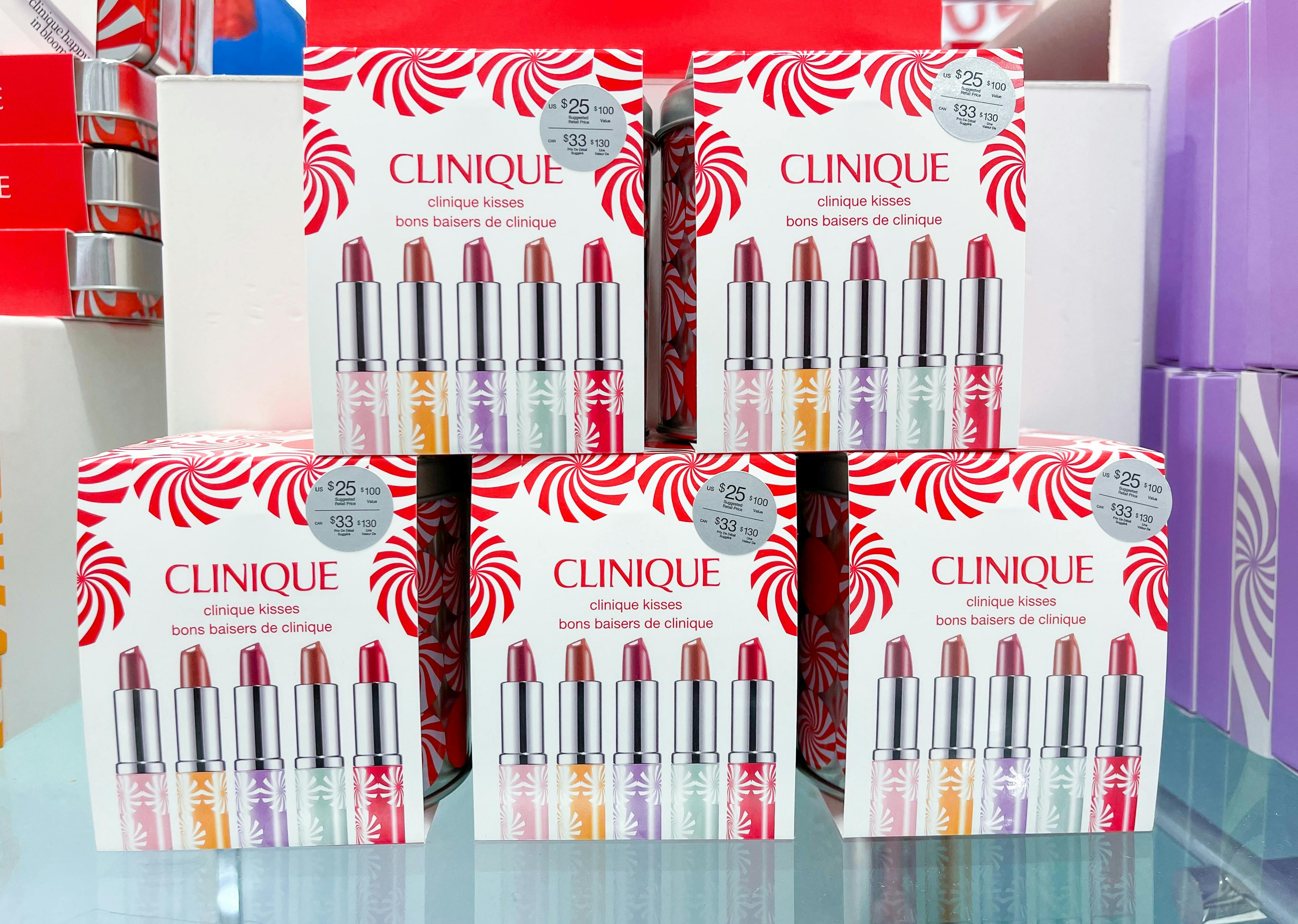 A display of Clinique makeup sets on a glass counter at Macy's.