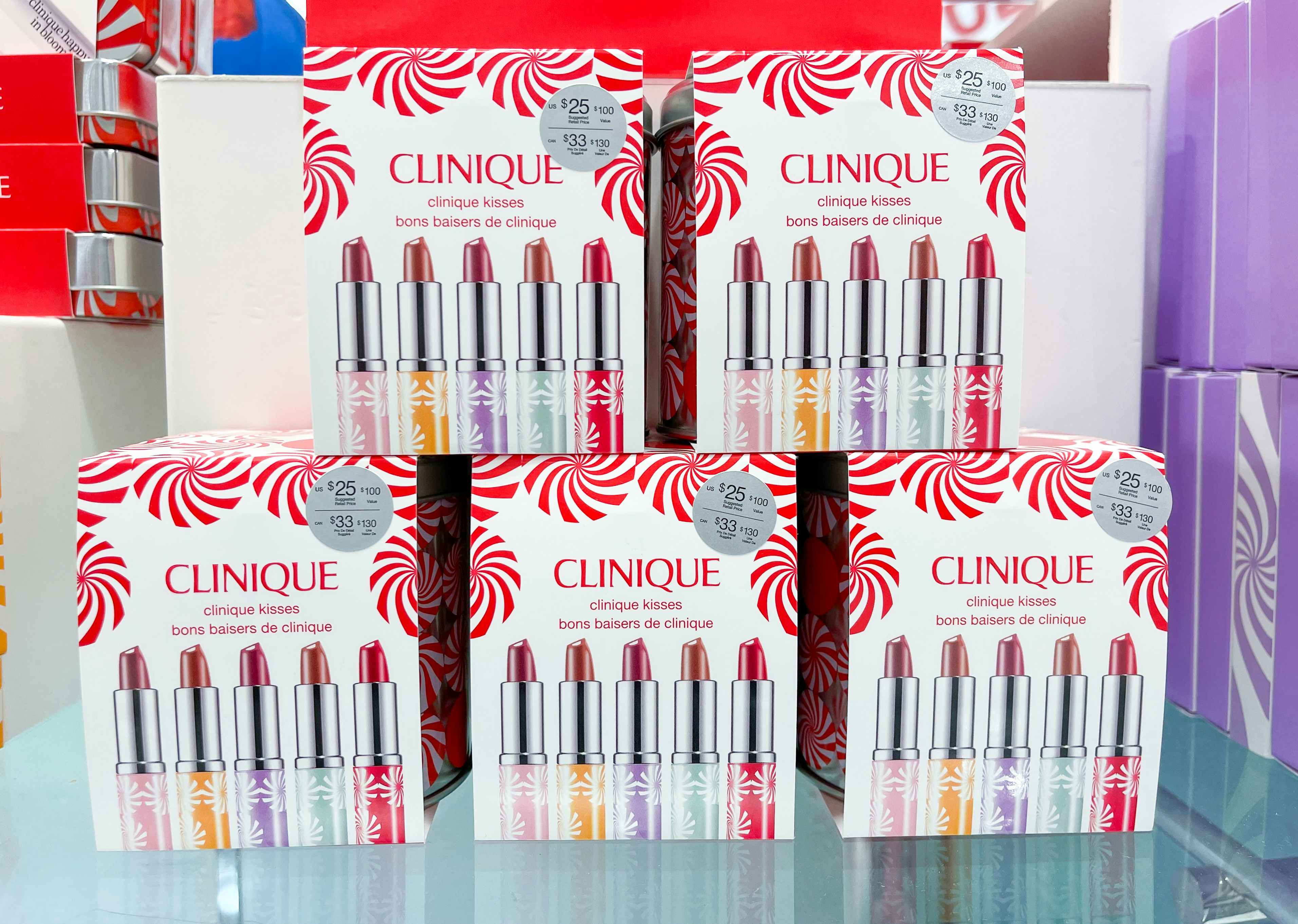 A display of Clinique makeup sets on a glass counter at Macy's.