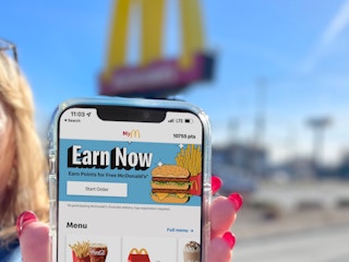 women holding cellphone with mcdonalds app