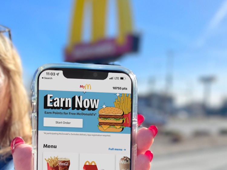 women holding cellphone with mcdonalds app