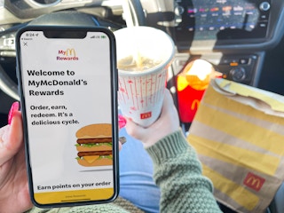 women holding cellphone with mcdonalds app
