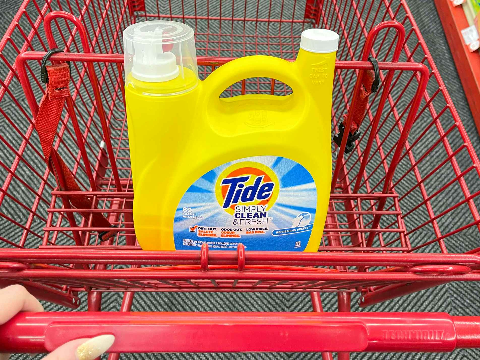 A 128oz container of Tide Simply Clean & Fresh detergent in a Staples shopping cart.