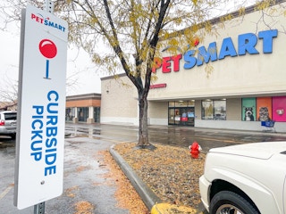 a car parked in the curbside pickup parking spot outside of PetSmart