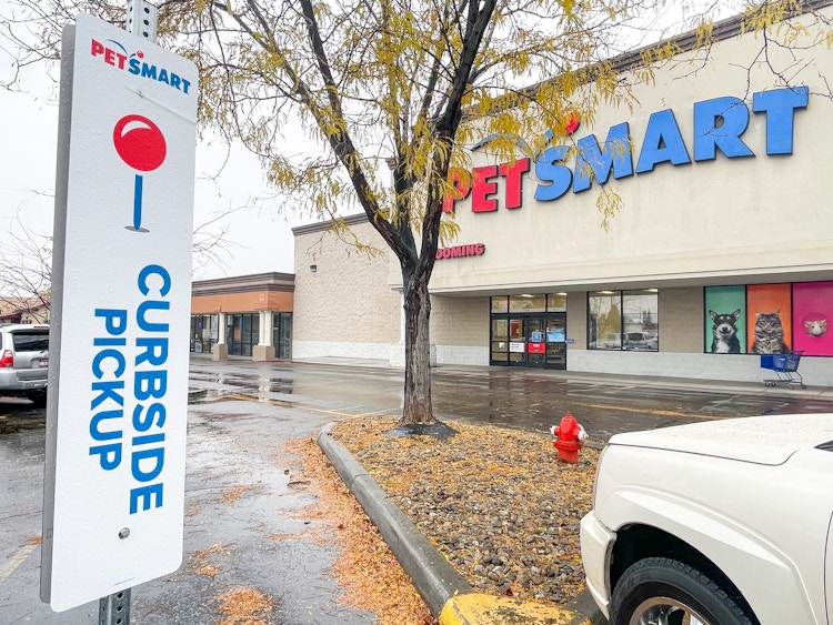 a car parked in the curbside pickup parking spot outside of PetSmart