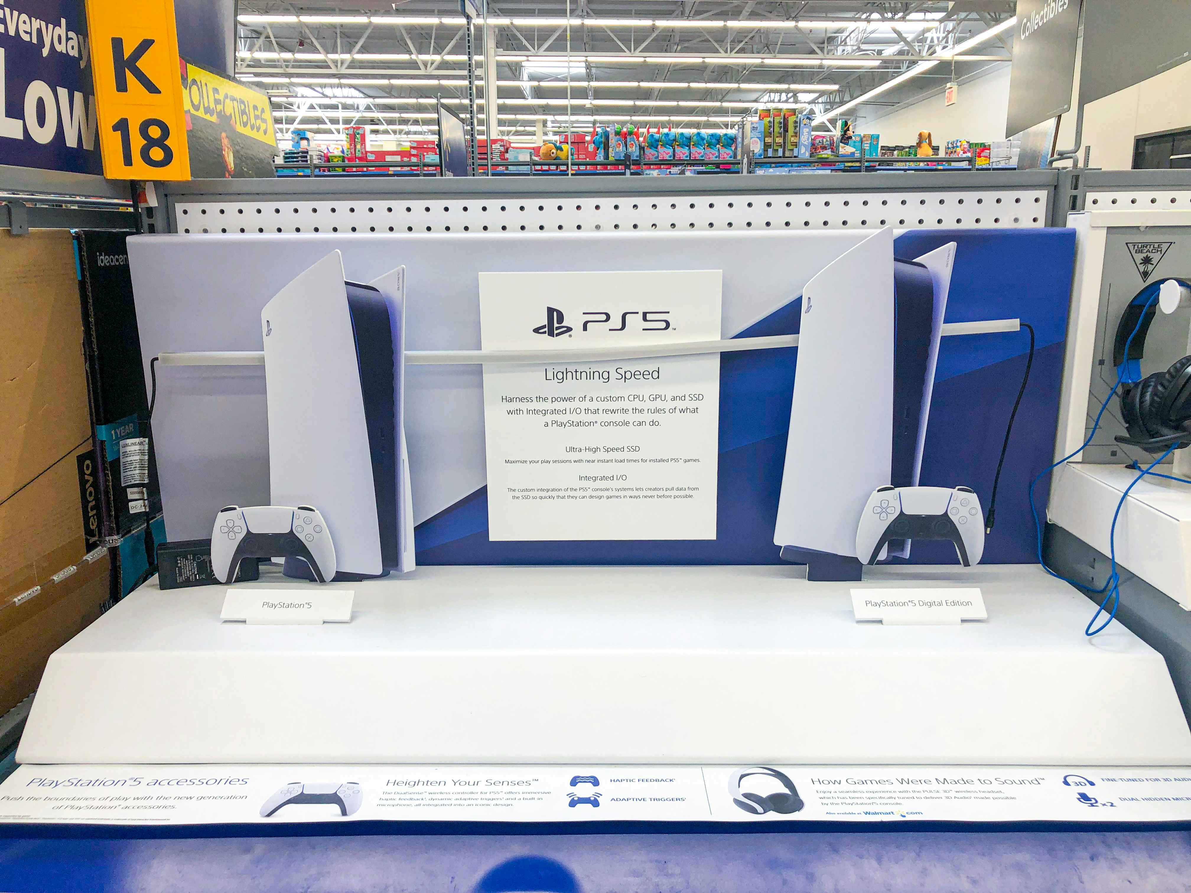 a PS5 product display inside Walmart electronics section.