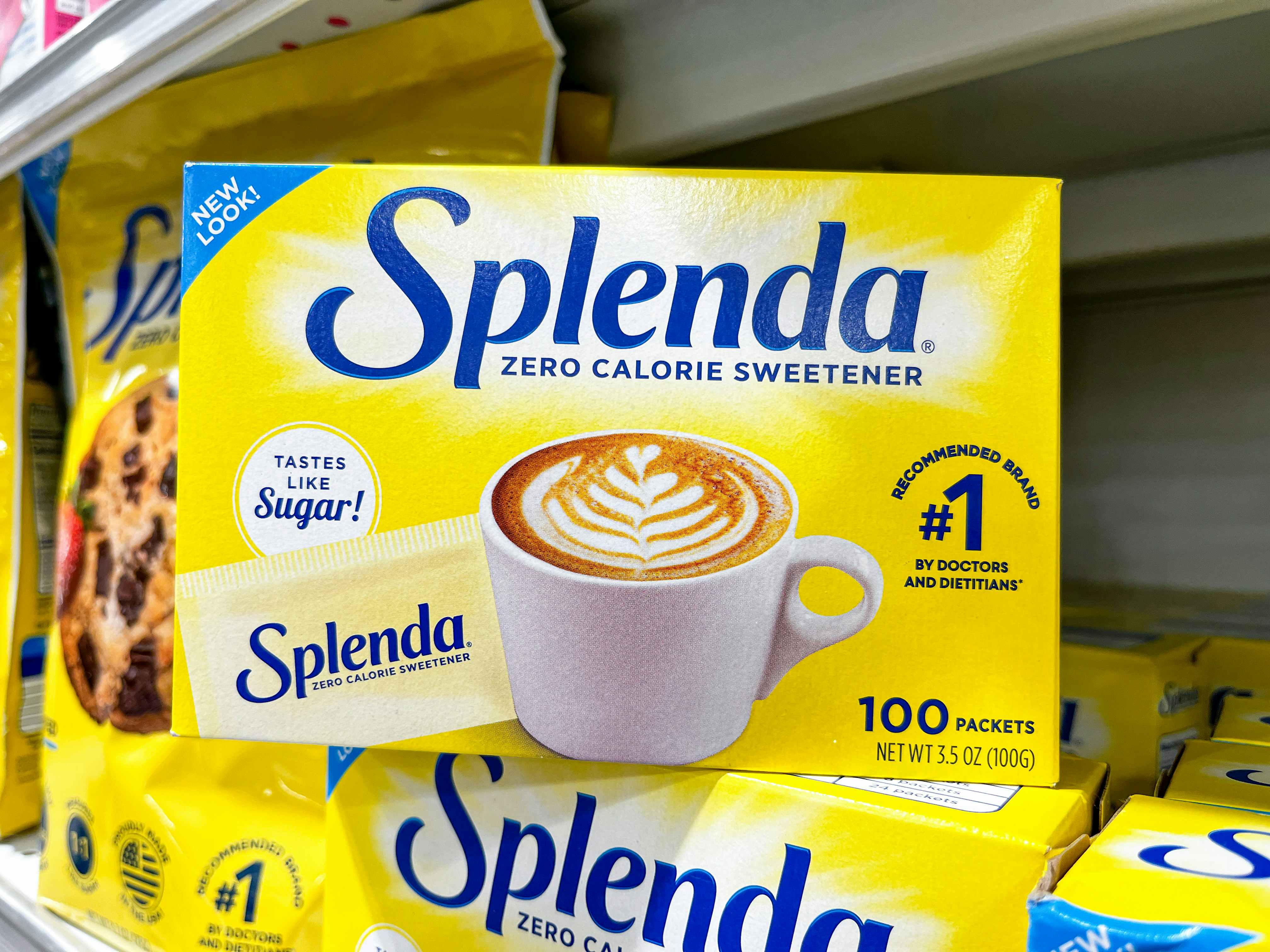 A box of 100 packets of Splenda sitting on another box of Splenda on the shelf at Publix.