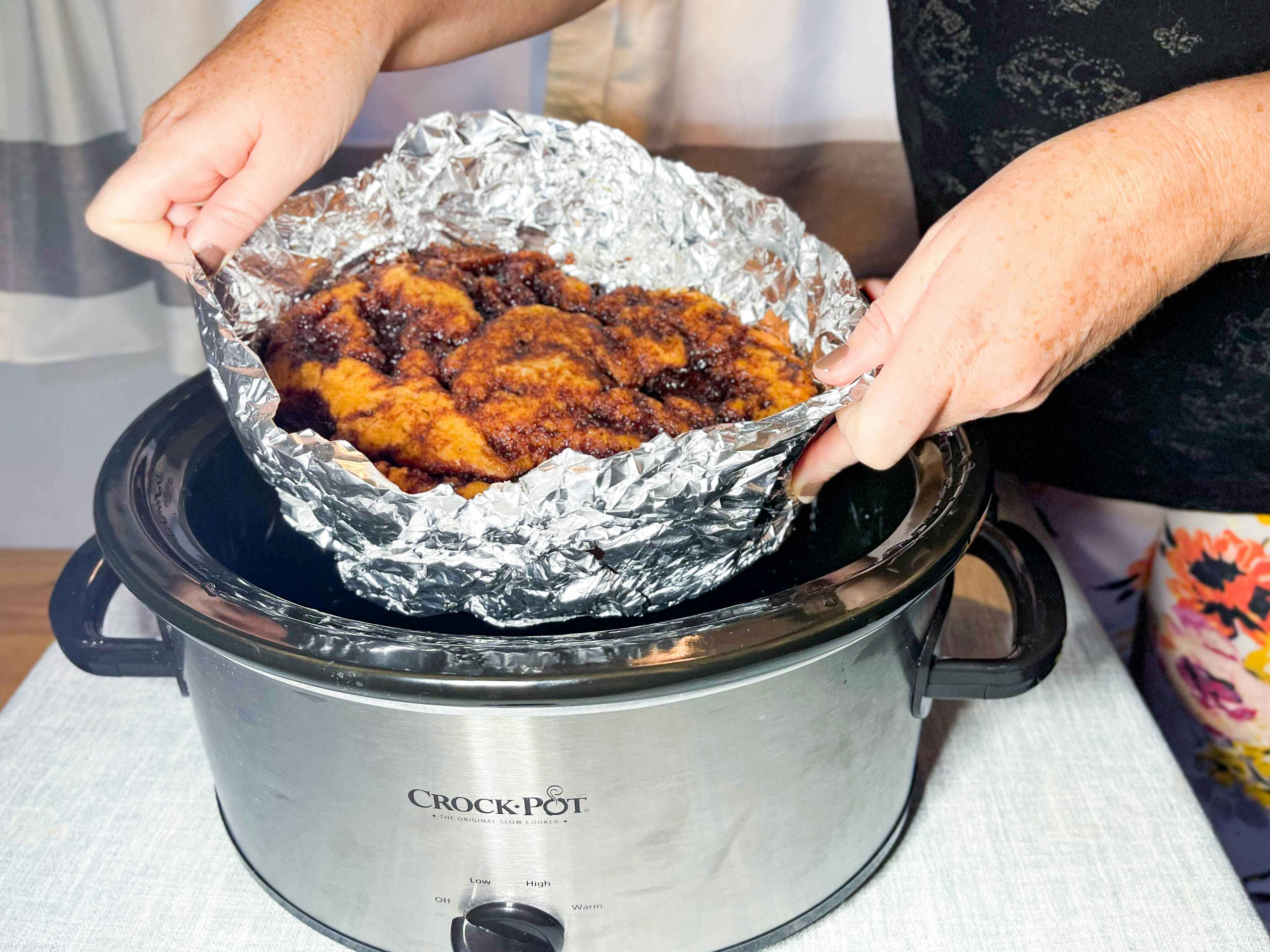 bread being pulled out of a crock pot