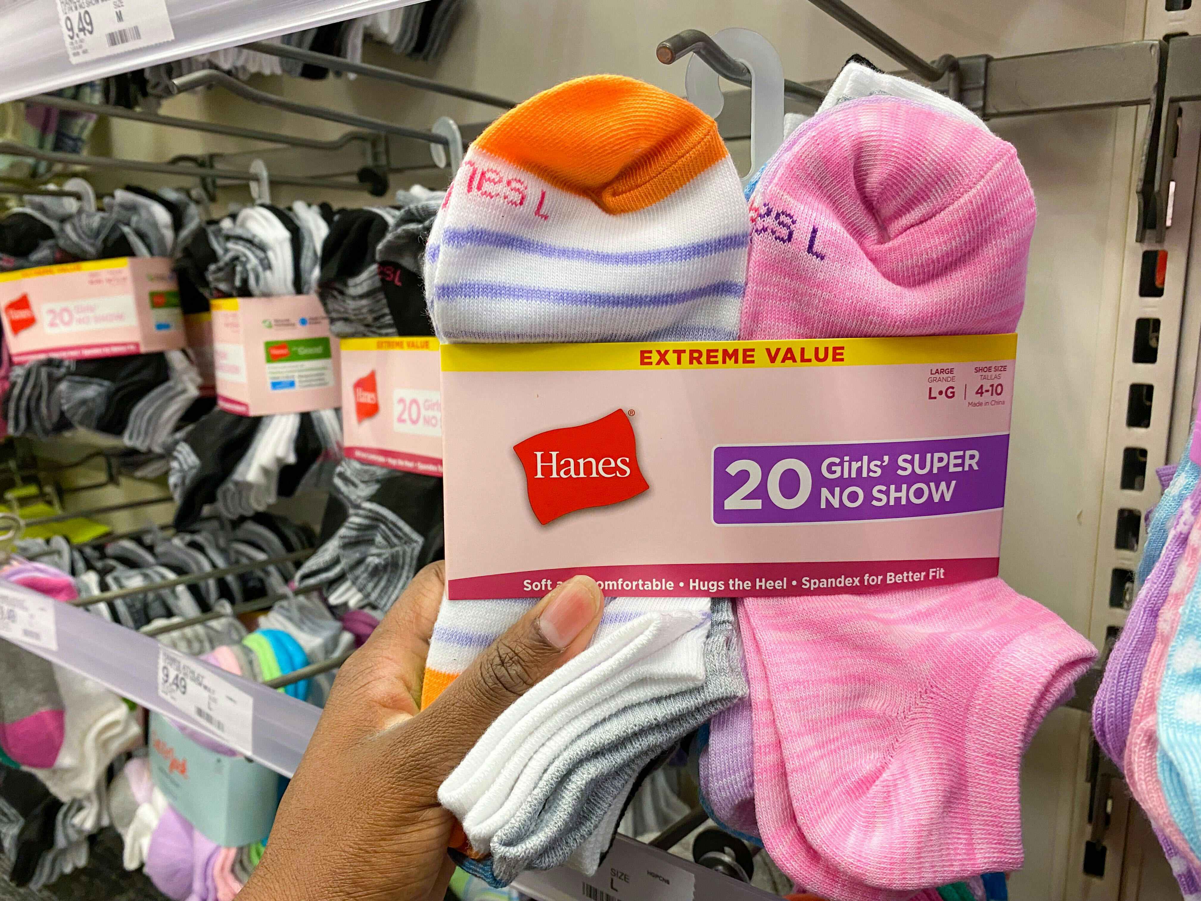 person holding a package of hanes girls super no-show 20-pack socks in target