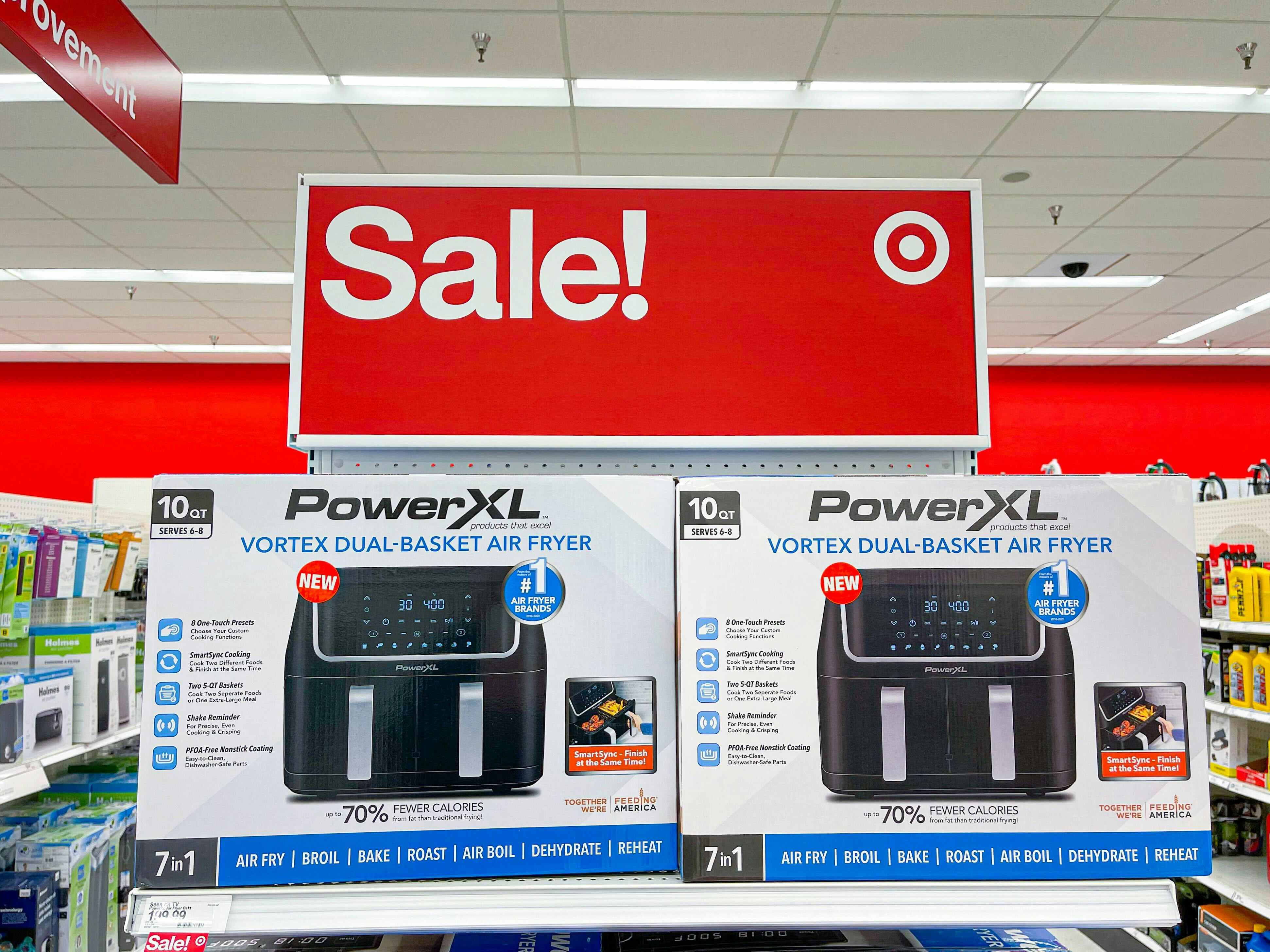 Air Fryers on a shelf at Target with a Sale sign above them