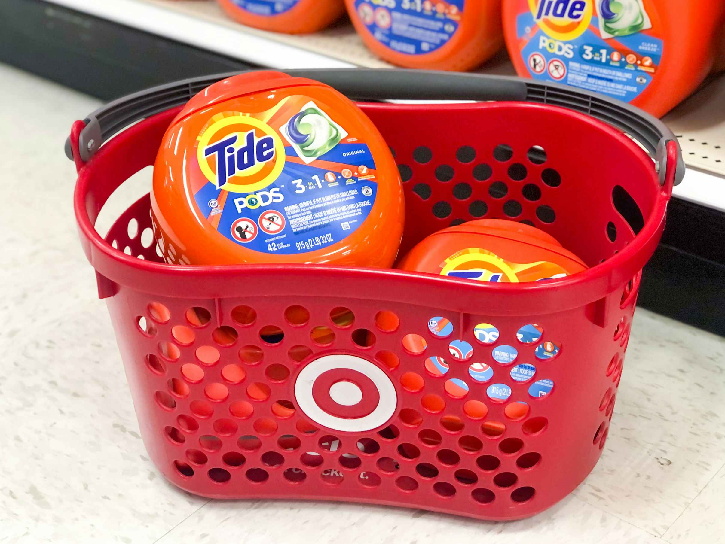 Target store shopping basket with bottles of Tide Pods in it