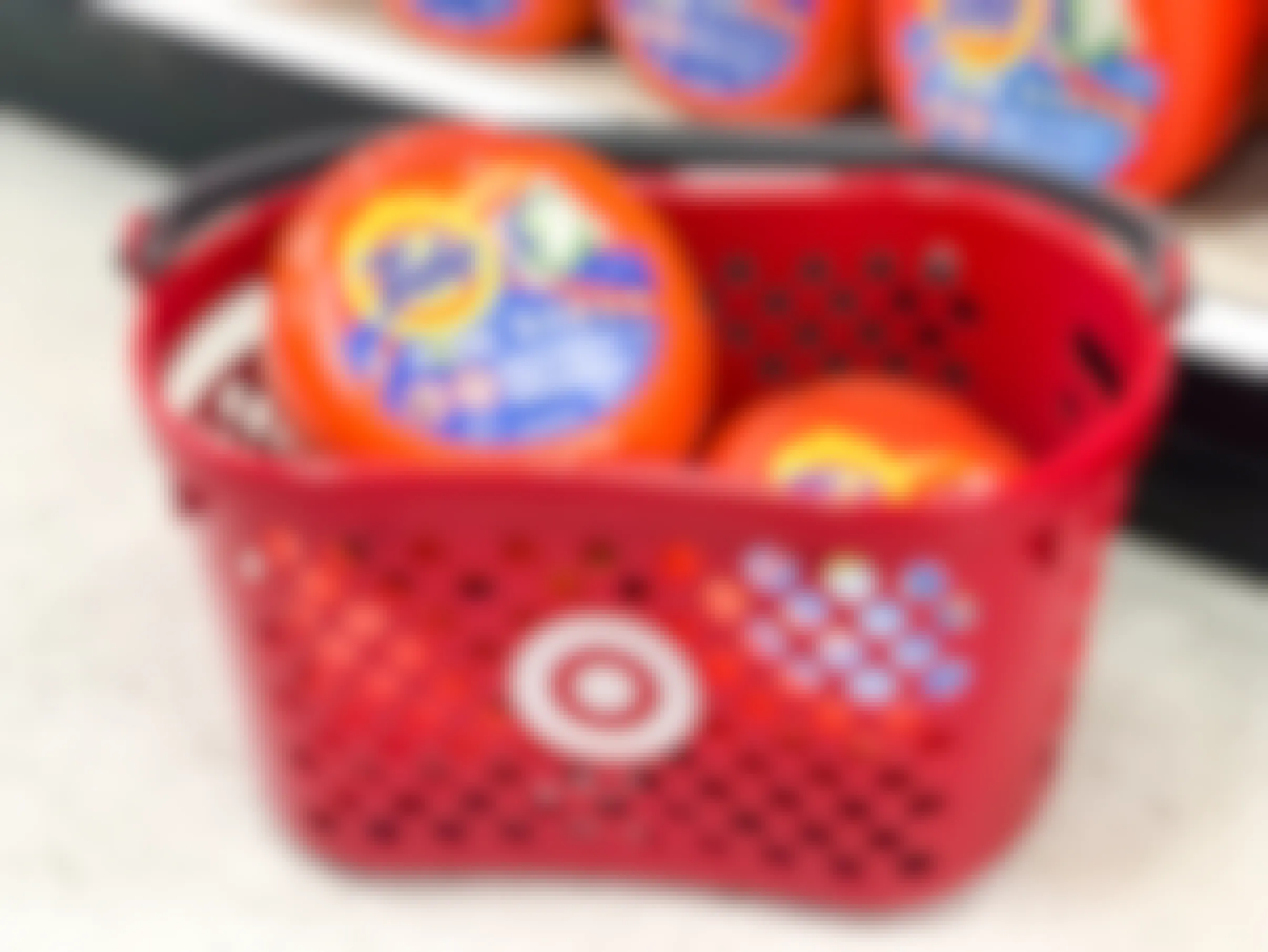 Target store shopping basket with bottles of Tide Pods in it
