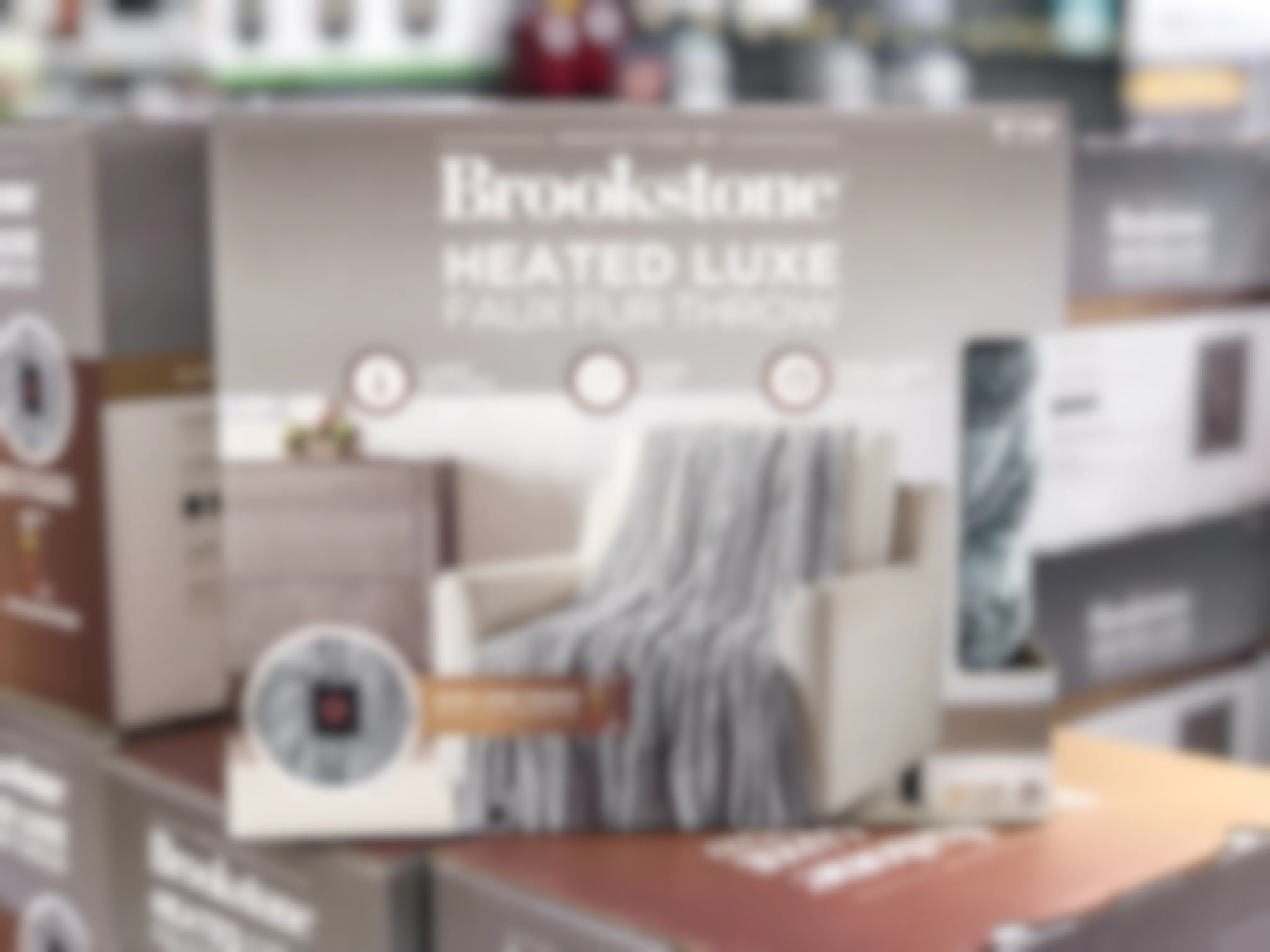 A Brookstone Heated Throw Blanket in its box on display at Walmart.