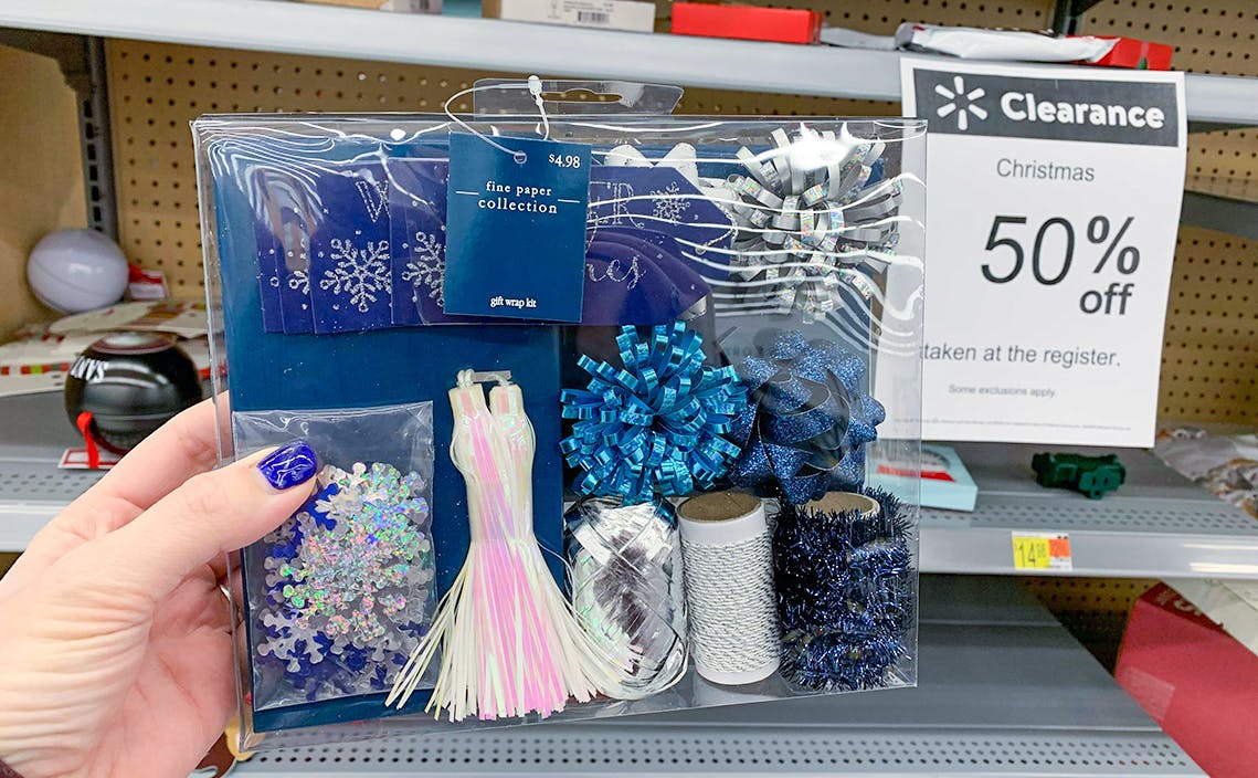 A blue and white gift wrap set in store with a 50% clearance sign nearby