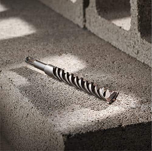 A Bosch bulldog rotary hammer bit on a cement block.