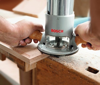 A Bosch router being used on wood.