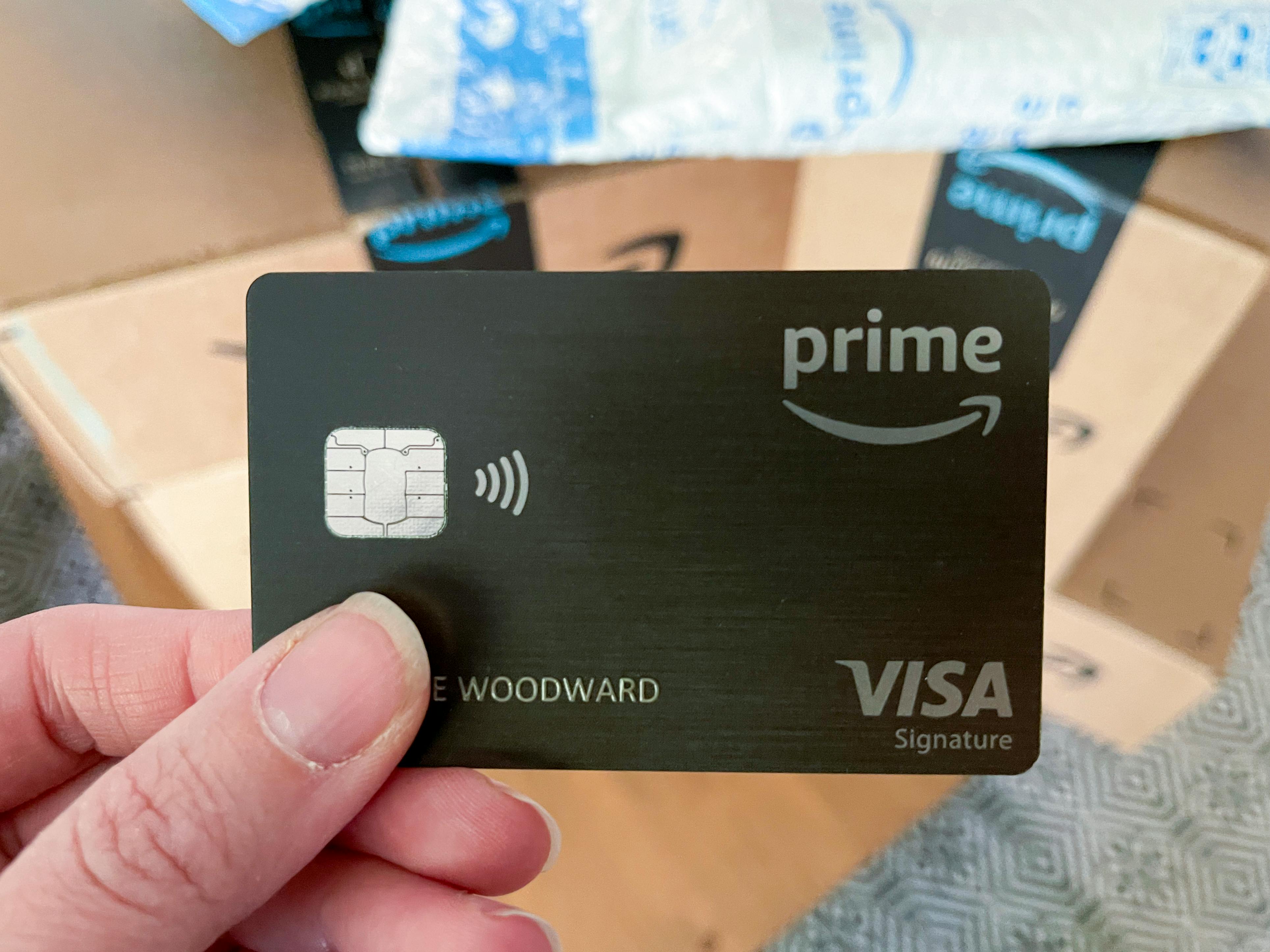 A person holding an amazon prime visa credit card.