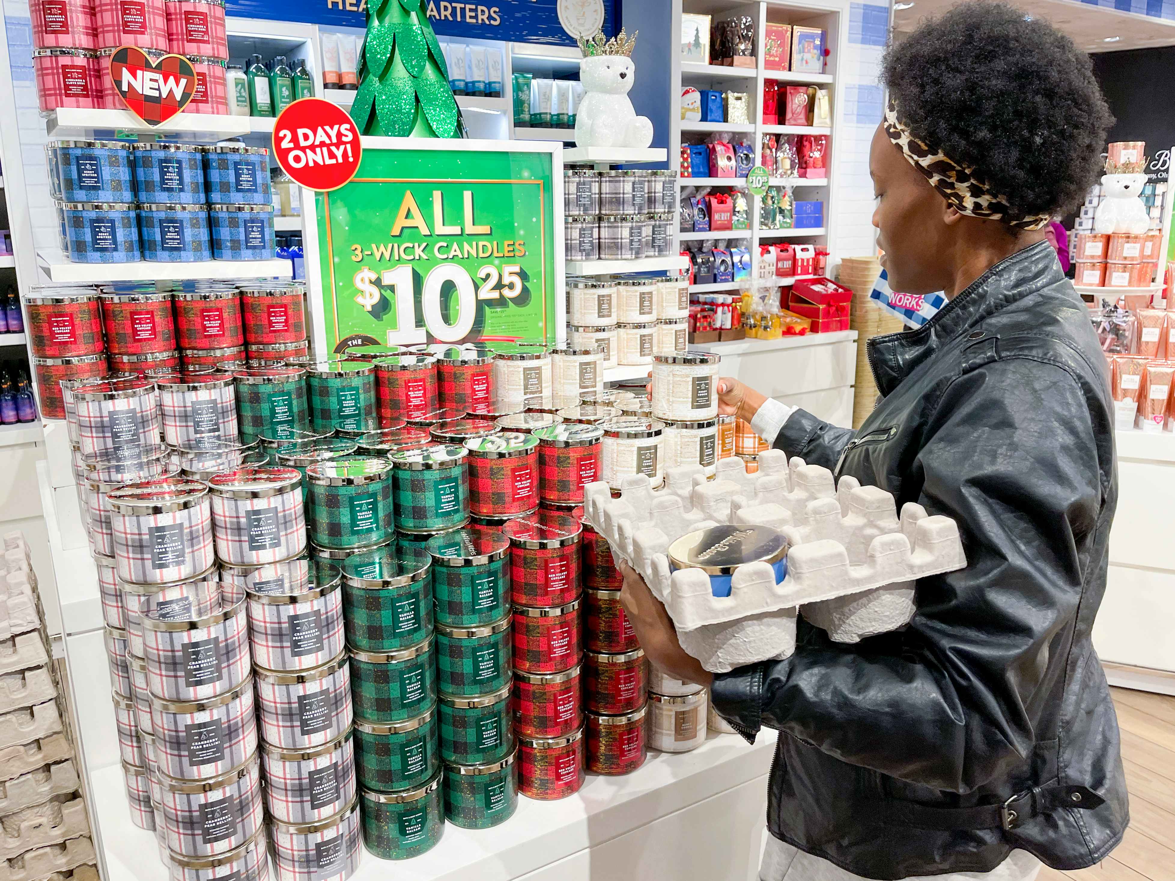 A woman looking at candles at Bath and Body works during the Candle Day sale.
