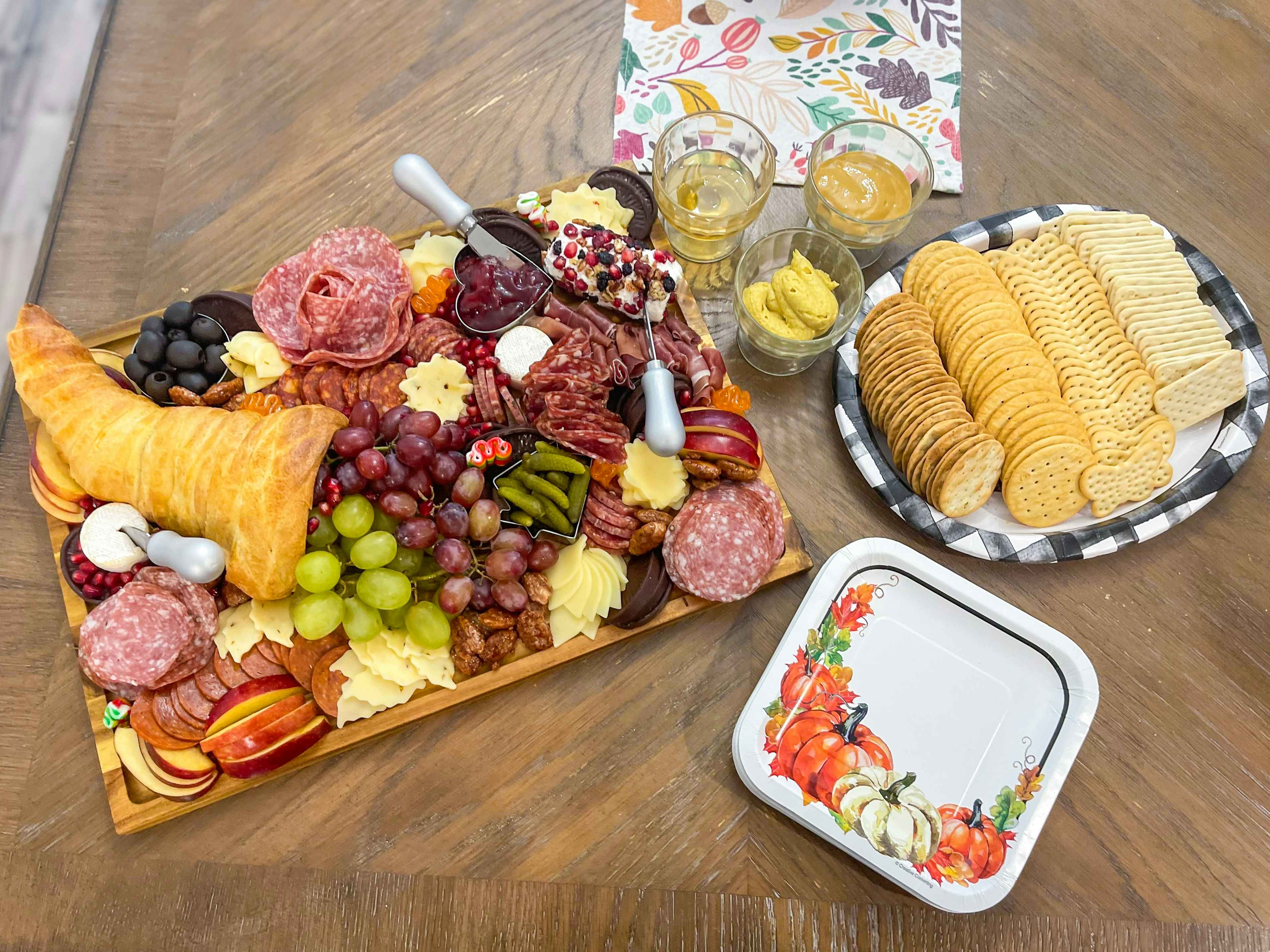 A Thanksgiving charcuterie board with meats, cheeses, and fruits coming out of a croissant cornucopia