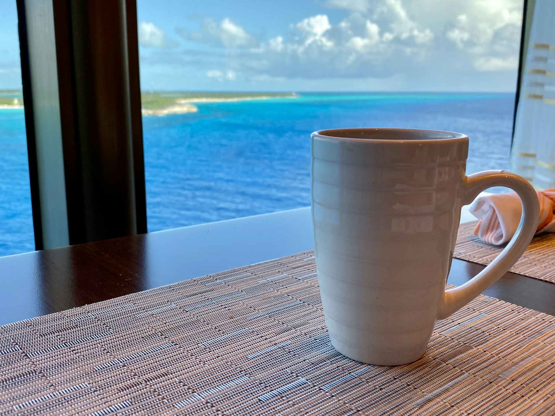 Cup of coffee in a cruise ship window