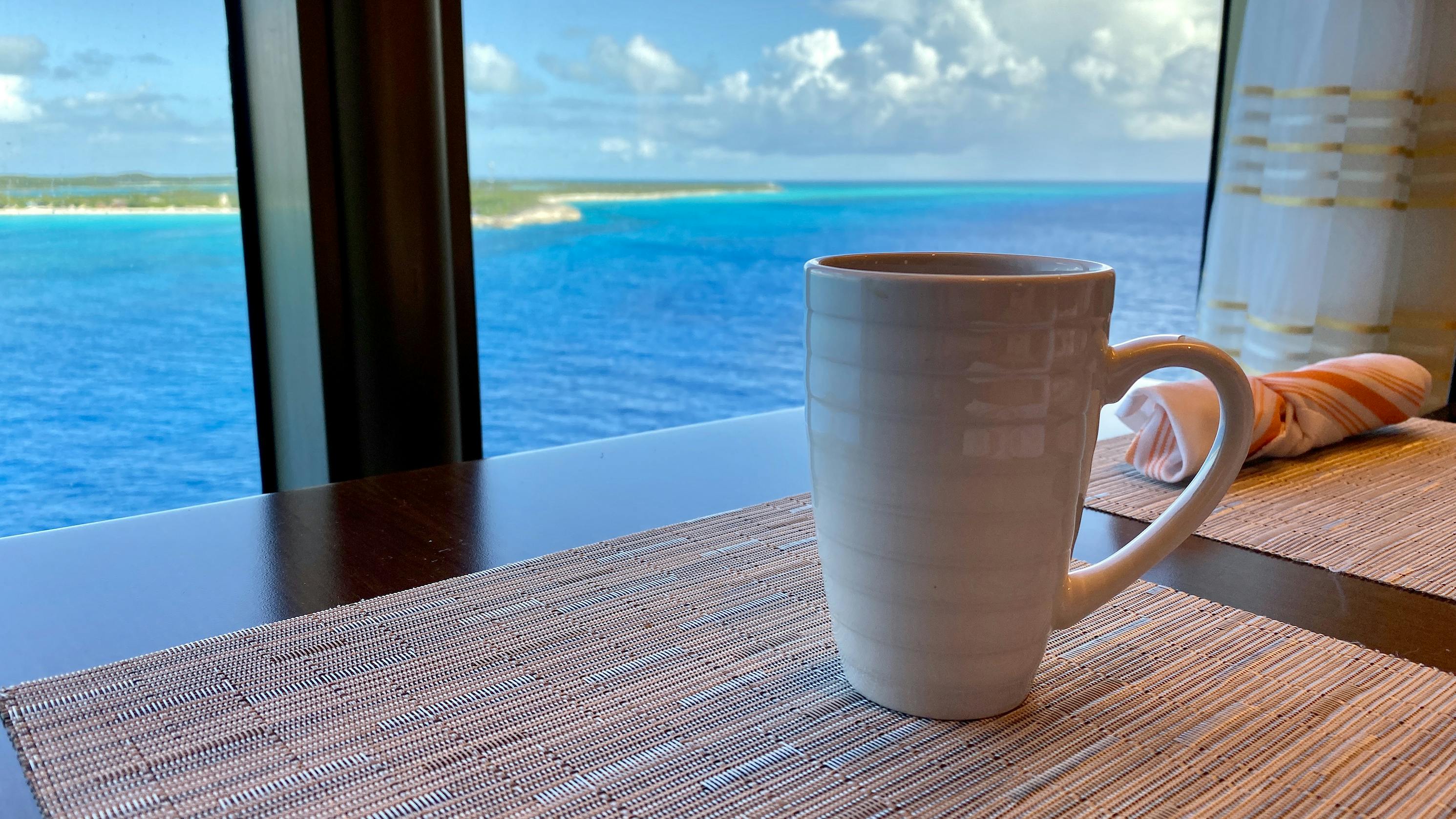 Cup of coffee in a cruise ship window