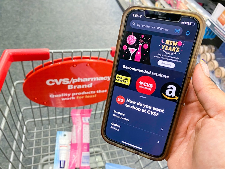 someone holding a phone with the Ibotta app. in cvs