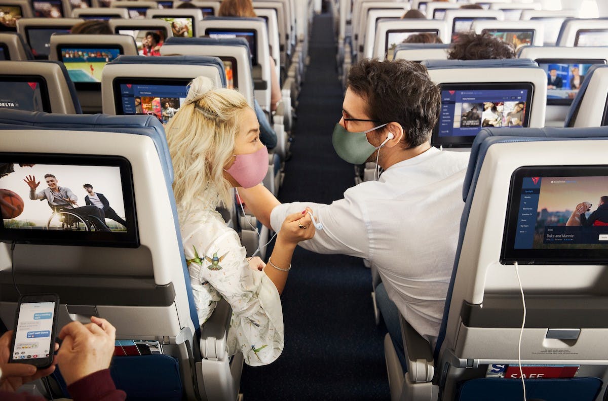 two people sitting in plane seats