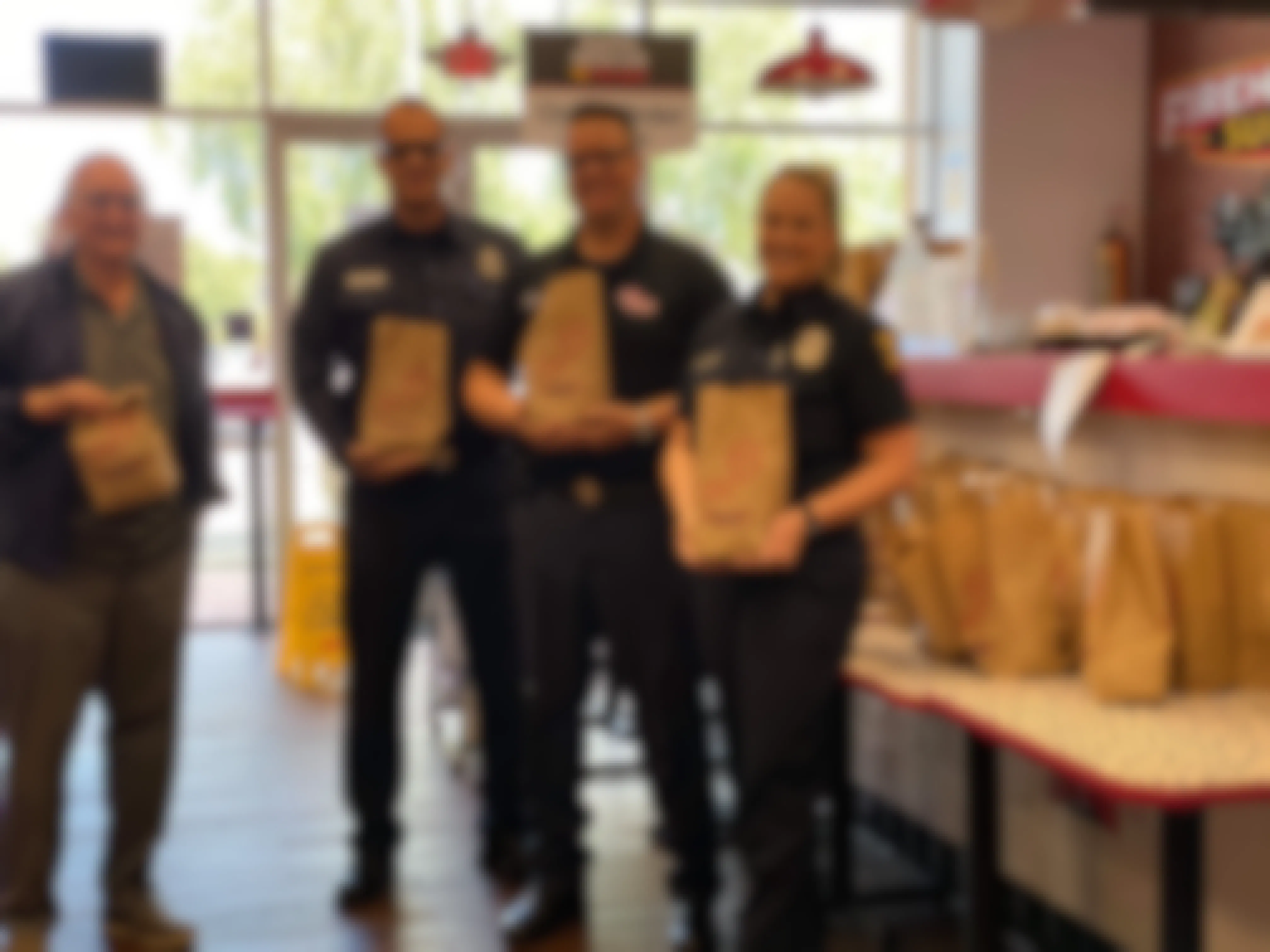 people holding firehouse subs bags