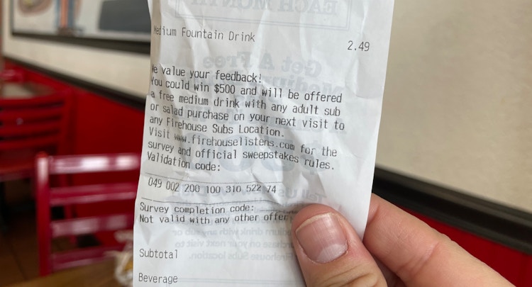 someone holding receipt from firehouse subs