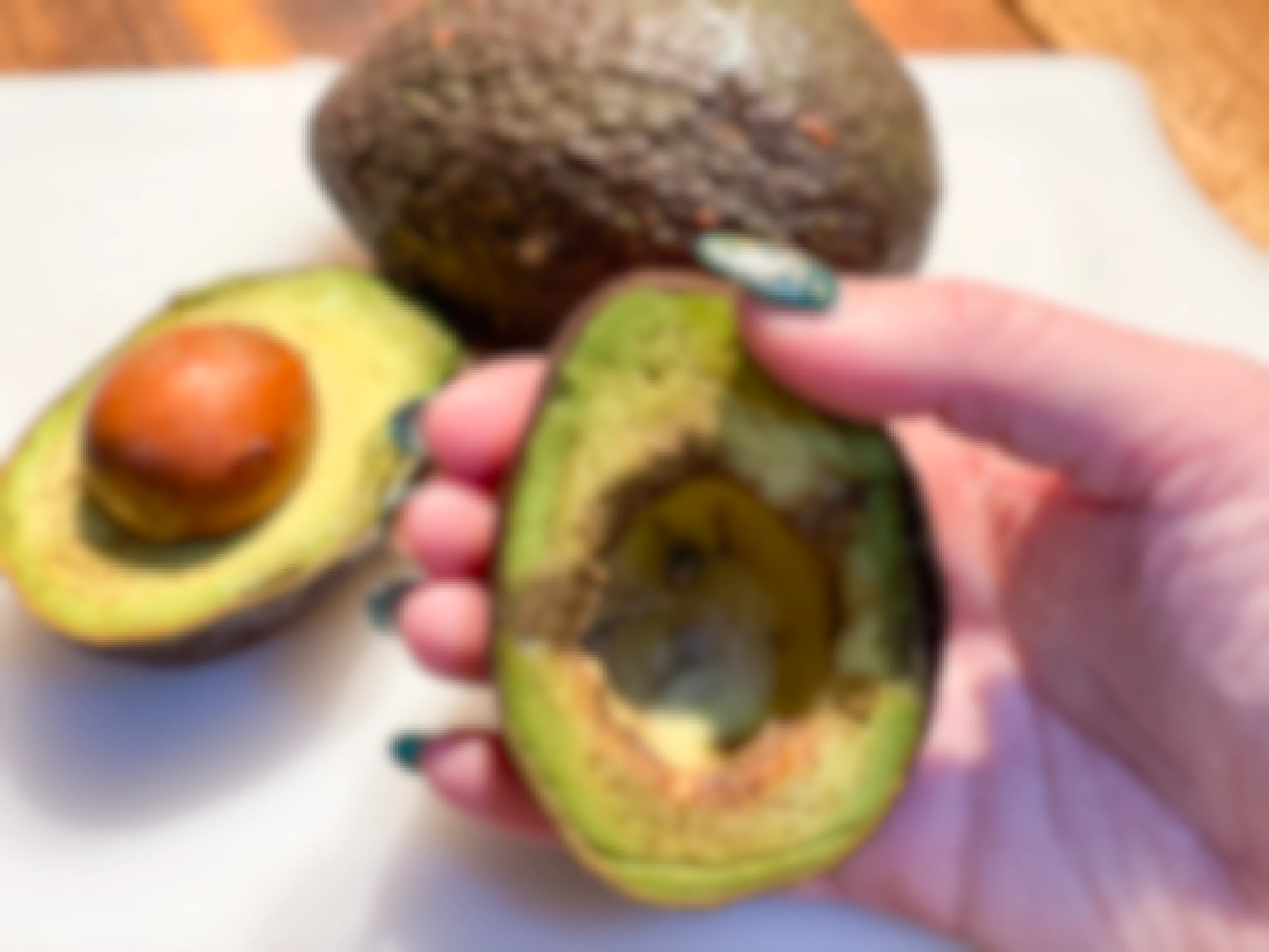 hand holding overripe avocado