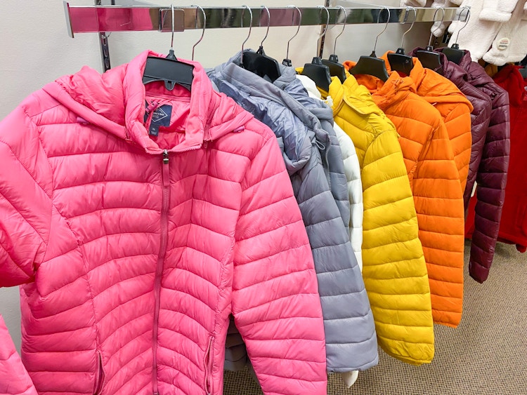 Puffer coats in different colors hanging on a clothing rack at JCPenney