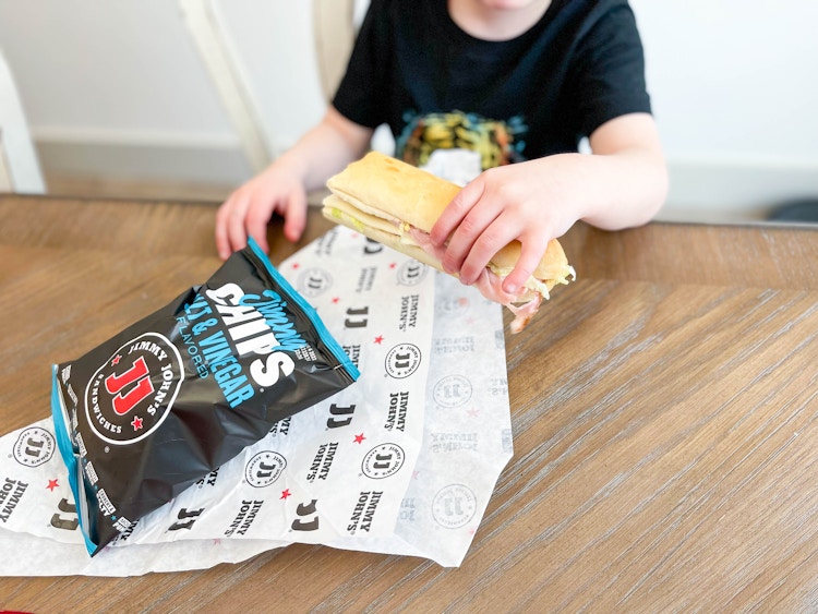 close up of boy eating jimmy johns 