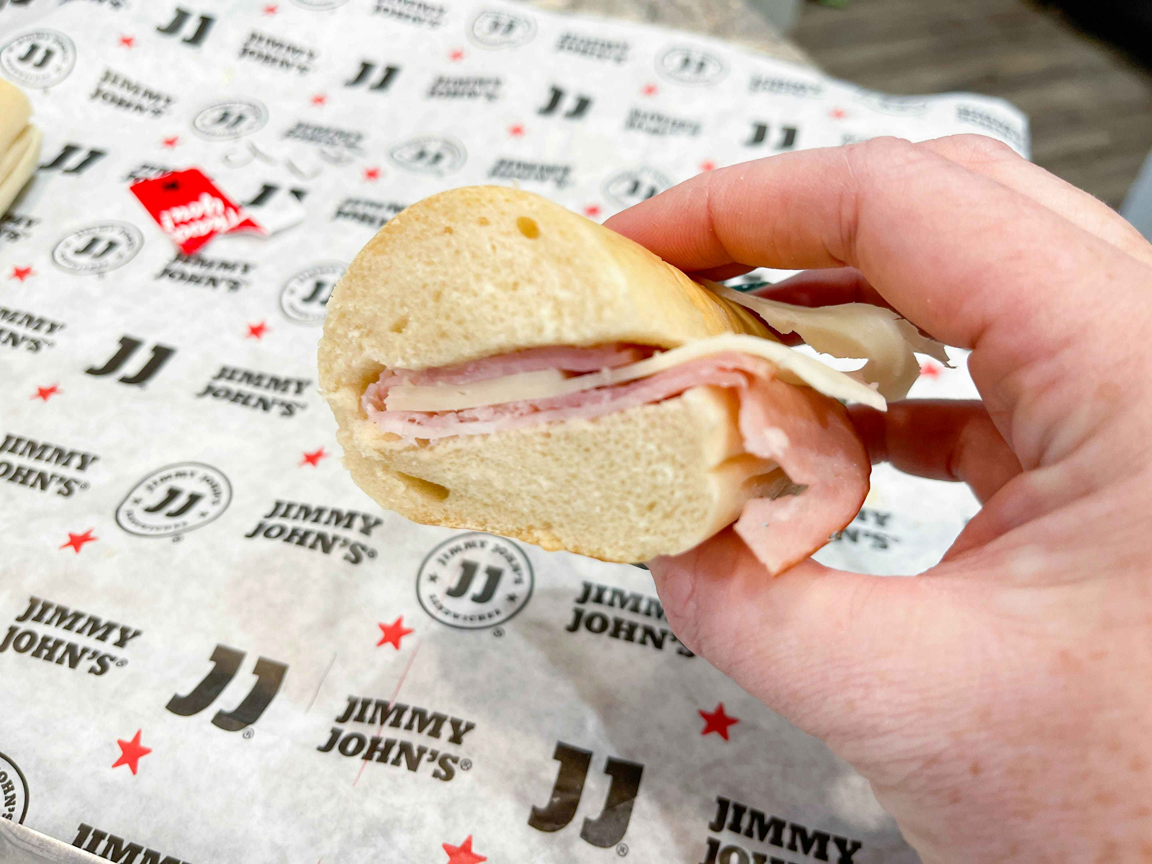 hand holding jimmy johns sandwich 