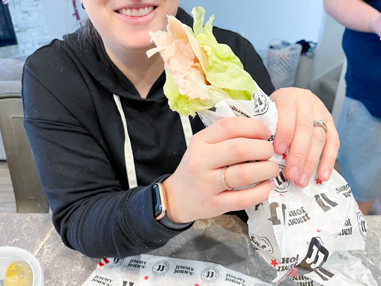 woman holding jimmy johns turkey unwich 