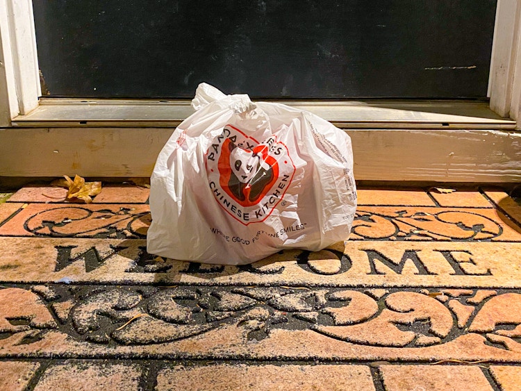 Panda Express bag in front of a front door