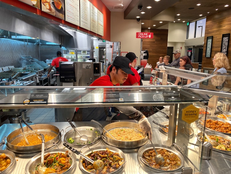 A Panda Express restaurant with employees serving customers