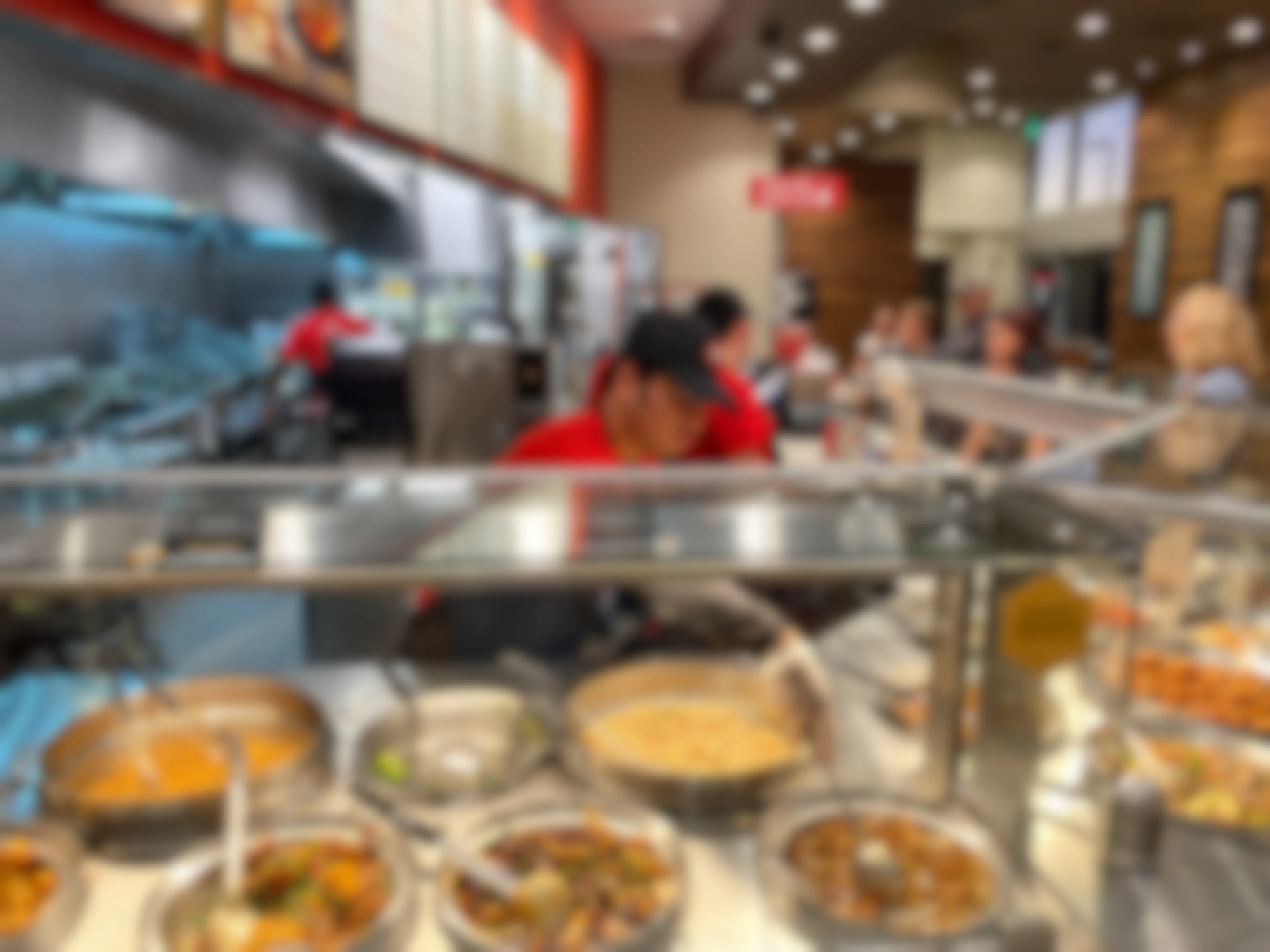 A Panda Express restaurant with employees serving customers