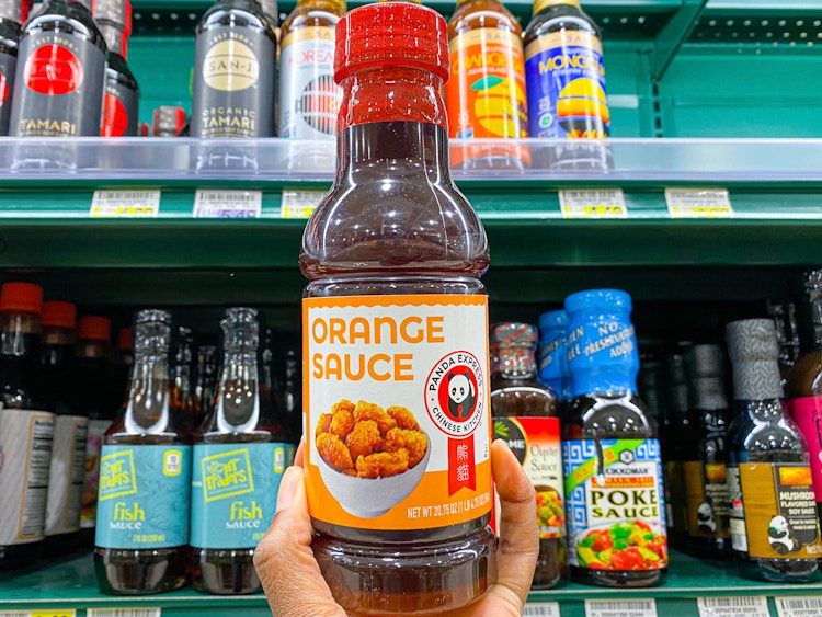 Panda Express sauce held in hand in front of the condiment section 