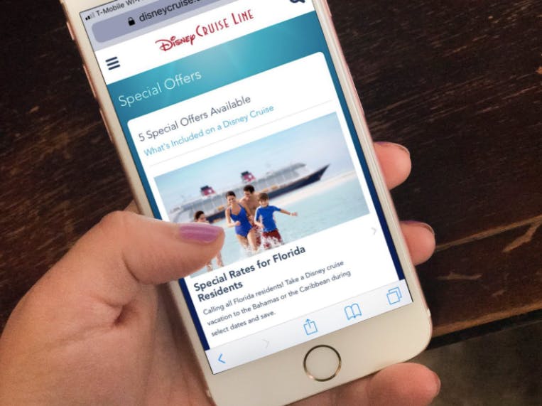 person holding a phone with Disney cruise special offers on it