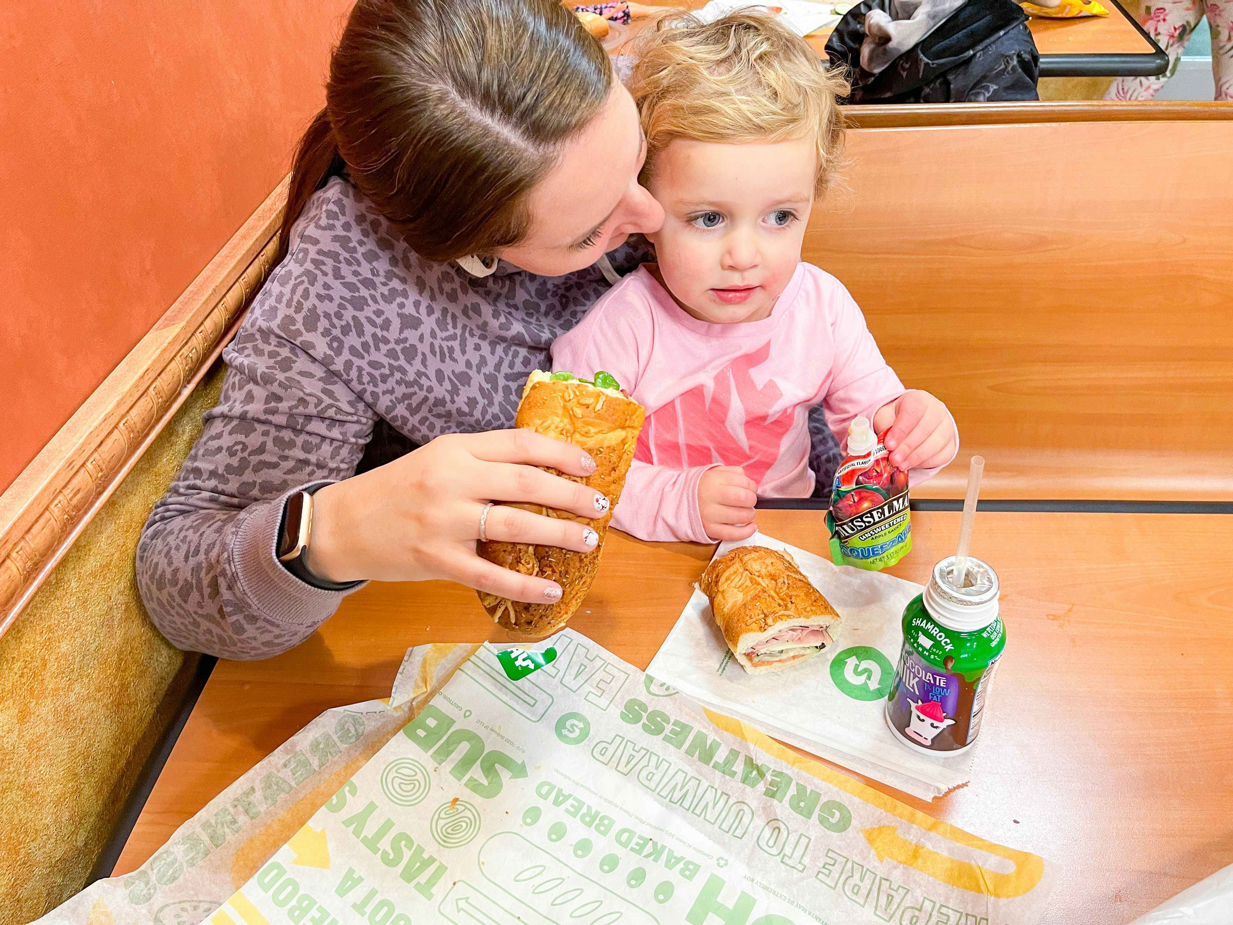 mom and daughter eating subway