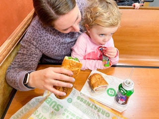 mom and daughter eating subway