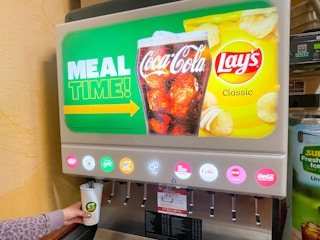 woman getting soda at subway