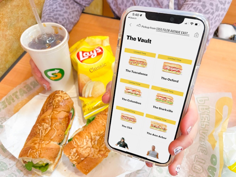 holding a phone with subway app in front of sub meal deal