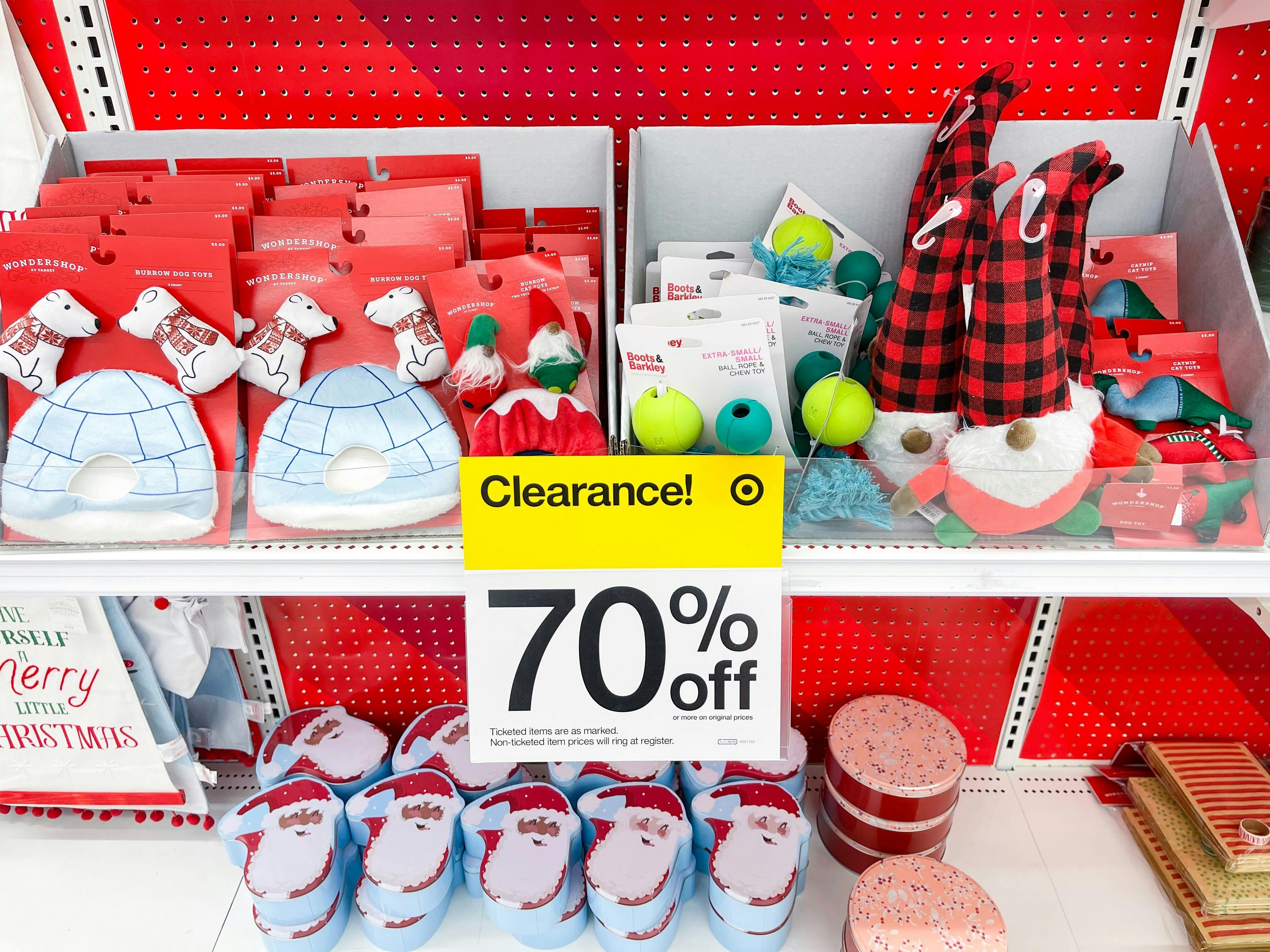 Christmas clearance on some shelves in Target with a sign showing them to be 70% off