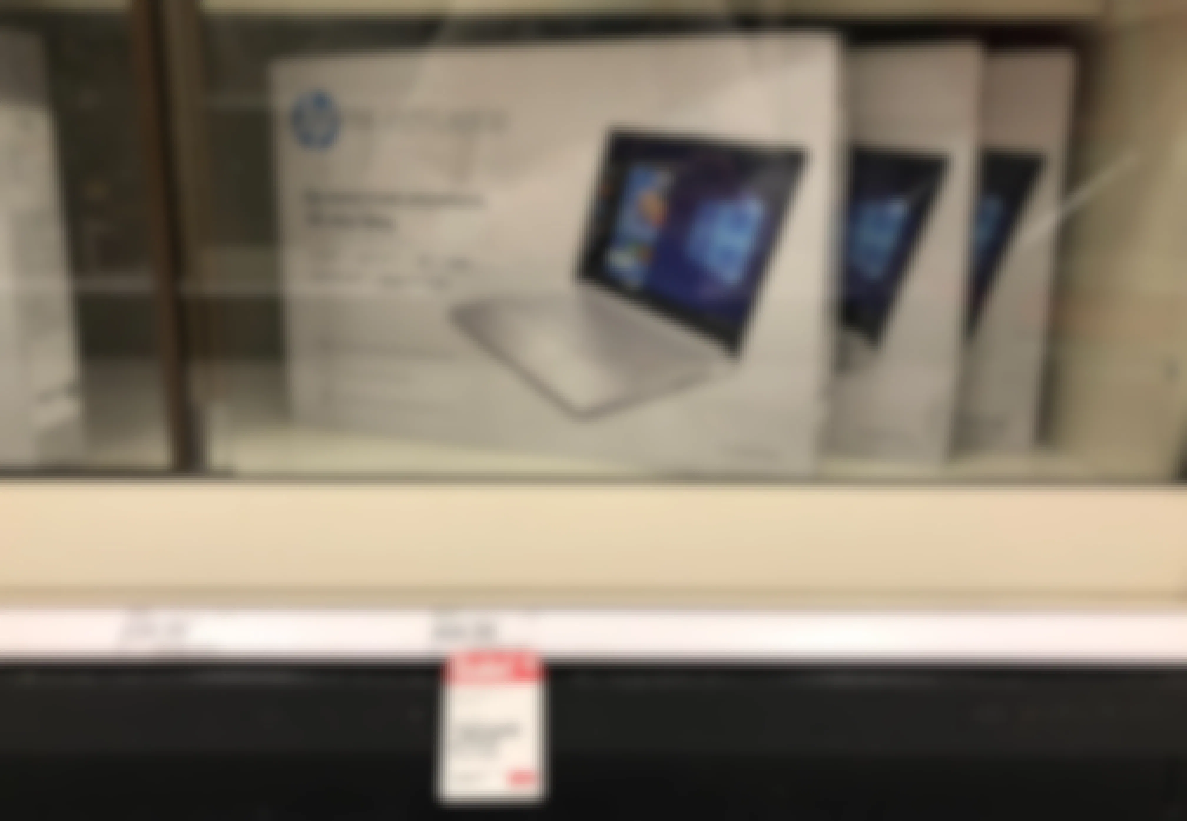 Some HP 14-Inch Windows Laptops in a locked case in the electronics department of Target.